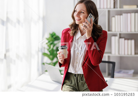 Concept of business office woman working,Businesswoman smile while working about her invesment plan with analyzing document and business investment graph data by using laptop on desk in workstation. 103195283