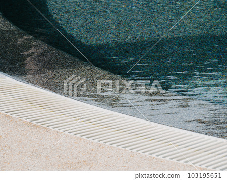 View of round swimming pool side with clear blue water with sunlight shadow wave reflections View of round swimming pool side with clear blue water with sunlight shadow wave reflections 103195651