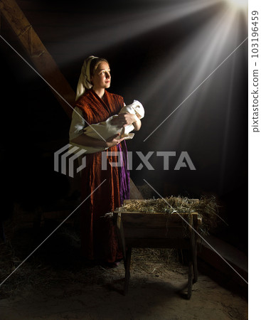 Mary in the stable near the manger with the baby Mary in the stable near the manger with the baby 103196459
