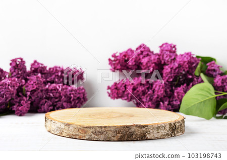 Wood slice podium and lilac flowers. Concept scene stage showcase for new product, banner, promotion sale, cosmetic, presentation Wood slice podium and lilac flowers. Concept scene stage showcase for new product, banner, promotion sale, cosmetic, presentation 103198743
