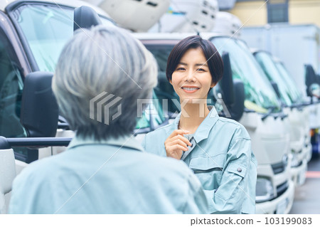Female worker having a meeting in front of the truck Female worker having a meeting in front of the truck 103199083