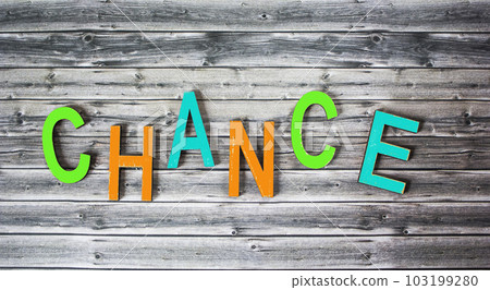 The word CHANCE consists of colored letters on a wooden background 103199280