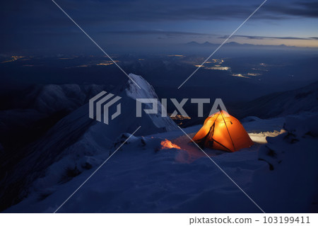 Experience the magic of the northern lights from a tent under a starry sky in a snowy wilderness at night. AI Generative 103199411