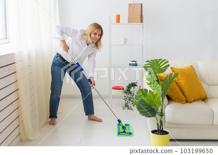 Portrait of housewife woman holds mop pad - cleaning concept 103199650
