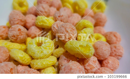 A set of colorful rings for breakfast. A collection of colorful cornflakes in milk. View from above 103199666