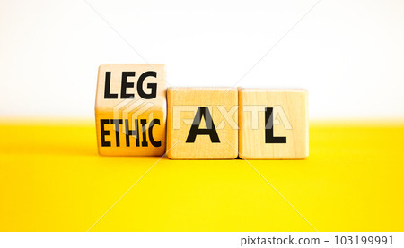 Ethical or legal symbol. Businessman turns wooden cubes and changes the word Ethical to Legal on a Beautiful yellow table white background. Business and ethical or legal concept. Copy space. Ethical or legal symbol. Businessman turns wooden cubes and changes the word Ethical to Legal on a Beautiful yellow table white background. Business and ethical or legal concept. Copy space. 103199991