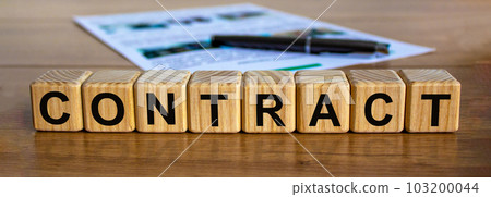 Concept word 'contract' on cubes on a beautiful wooden table, pen and documents. Business concept. Concept word 'contract' on cubes on a beautiful wooden table, pen and documents. Business concept. 103200044