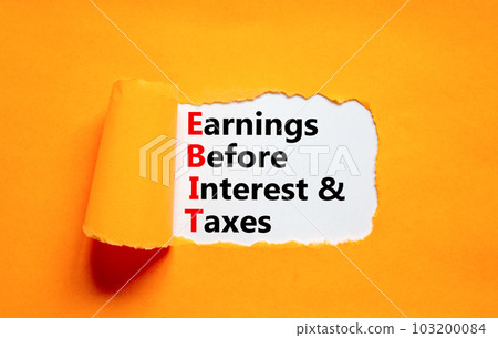 EBIT symbol. Concept words EBIT earnings before interest and taxes on white paper on beautiful orange background. Business EBIT earnings before interest and taxes concept. Copy space. 103200084