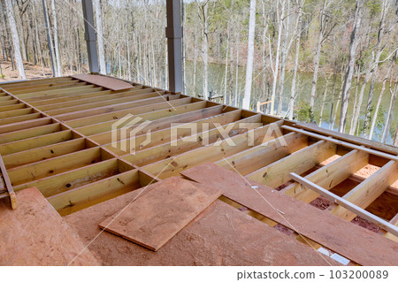 In new built custom home new flooring joists were constructed for wooden deck patio due to new construction 103200089
