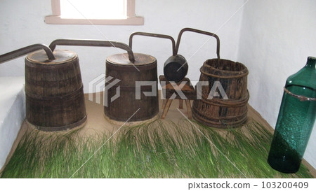 An old Ukrainian moonshine machine. Equipment for the production of homemade strong alcohol. An old Ukrainian moonshine machine. Equipment for the production of homemade strong alcohol. 103200409