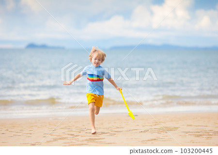 Kids play on tropical beach. Sand and water toy. Kids play on tropical beach. Sand and water toy. 103200445
