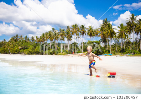 Kids play on tropical beach. Sand and water toy. Kids play on tropical beach. Sand and water toy. 103200457