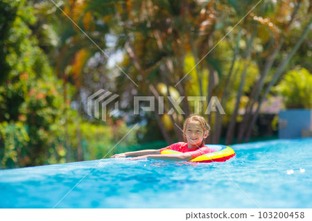 Child in swimming pool on toy ring. Kids swim. Child in swimming pool on toy ring. Kids swim. 103200458