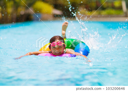 Child in swimming pool on toy ring. Kids swim. Child in swimming pool on toy ring. Kids swim. 103200646