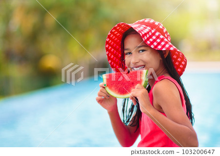 Child with watermelon in swimming pool Child with watermelon in swimming pool 103200647