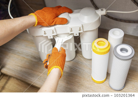 Plumber installs or change water filter. Replacement aqua filter Plumber installs or change water filter. Replacement aqua filter 103201364