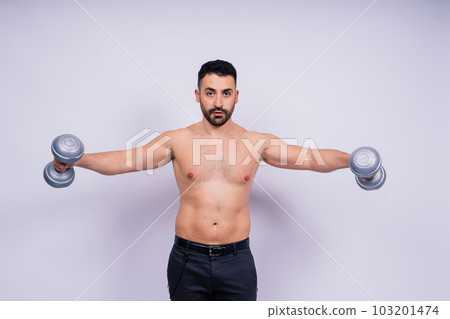 Athletic man doing exercises with dumbbell at biceps on white background. Strength and motivation 103201474