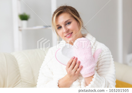 Woman hand holding massage sponge - spa and body care concept Woman hand holding massage sponge - spa and body care concept 103201505