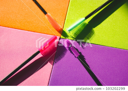 Set of multicolored silicone mascara brushes on a multicolored bright background. Green, pink, purple, orange lash brushes. Modern decorative cosmetics for women. Female beauty and glamour fashion. Set of multicolored silicone mascara brushes on a multicolored bright background. Green, pink, purple, orange lash brushes. Modern decorative cosmetics for women. Female beauty and glamour fashion. 103202299