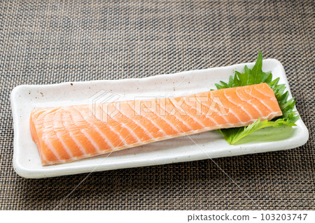 A fence of raw salmon for sashimi. 103203747