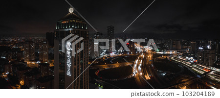 Aerial view of the Istambul business district. Rapidly developing business and finance area of Istanbul with highrises and shopping malls. Commercial buildings at night 103204189