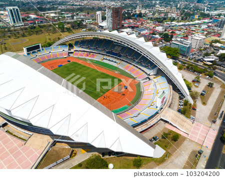 View of the National Stadium of Costa Rica. San Jose, Costa rica capital city street view with mountains in the background. View of the National Stadium of Costa Rica. San Jose, Costa rica capital city street view with mountains in the background. 103204200