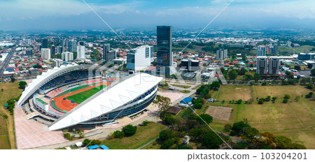 View of the National Stadium of Costa Rica. San Jose, Costa rica capital city street view with mountains in the background. View of the National Stadium of Costa Rica. San Jose, Costa rica capital city street view with mountains in the background. 103204201