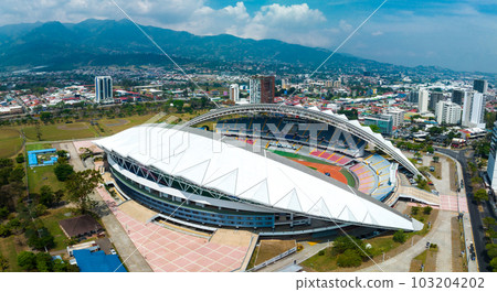 View of the National Stadium of Costa Rica. San Jose, Costa rica capital city street view with mountains in the background. View of the National Stadium of Costa Rica. San Jose, Costa rica capital city street view with mountains in the background. 103204202