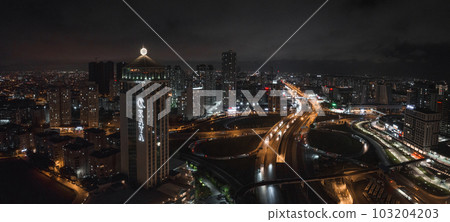 Aerial view of the Istambul business district. Rapidly developing business and finance area of Istanbul with highrises and shopping malls. Commercial buildings at night Aerial view of the Istambul business district. Rapidly developing business and finance area of Istanbul with highrises and shopping malls. Commercial buildings at night 103204203