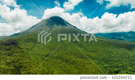 Amazing view of beautiful Arenal volcano in Costa Rica. Panorama of volcano Arenal reflected on wonderful picturesque lake, La Fortuna, Costa Rica. Central America. Amazing view of beautiful Arenal volcano in Costa Rica. Panorama of volcano Arenal reflected on wonderful picturesque lake, La Fortuna, Costa Rica. Central America. 103204251