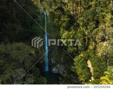 La Fortuna Waterfall in Costa Rica. The waterfall is located on the Arenal River at the base of the dormant Chato volcano. Long exposure. 103204288
