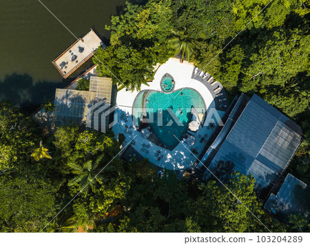 Luxury lodge in the middle of the jungle in Tortuguero, Costa Rica. Caribbean sea on the one side, village inside the jungle in the middle, and huge river on the otjer side. 103204289
