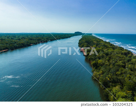 Caribbean sea on the one side, village Tortuguero inside the jungle in the middle, and huge river on the otjer side. Amazing place full of wildlife in Costa Rica Caribbean sea on the one side, village Tortuguero inside the jungle in the middle, and huge river on the otjer side. Amazing place full of wildlife in Costa Rica 103204325
