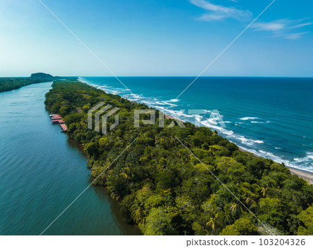 Caribbean sea on the one side, village Tortuguero inside the jungle in the middle, and huge river on the otjer side. Amazing place full of wildlife in Costa Rica 103204326