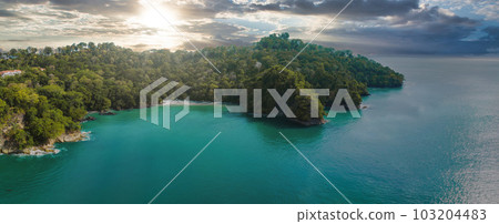 Aerial view of Manuel Antonio National Park in Costa Rica. The best Tourist Attraction and Nature Reserve with lots of Wildlife, Tropical Plants and paradisiacal Beaches on the Pacific Coast. Aerial view of Manuel Antonio National Park in Costa Rica. The best Tourist Attraction and Nature Reserve with lots of Wildlife, Tropical Plants and paradisiacal Beaches on the Pacific Coast. 103204483