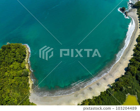 Aerial view of Manuel Antonio National Park in Costa Rica. The best Tourist Attraction and Nature Reserve with lots of Wildlife, Tropical Plants and paradisiacal Beaches on the Pacific Coast. Aerial view of Manuel Antonio National Park in Costa Rica. The best Tourist Attraction and Nature Reserve with lots of Wildlife, Tropical Plants and paradisiacal Beaches on the Pacific Coast. 103204489