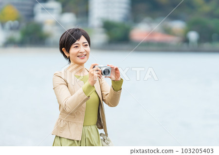 Woman taking a photo while sightseeing 103205403