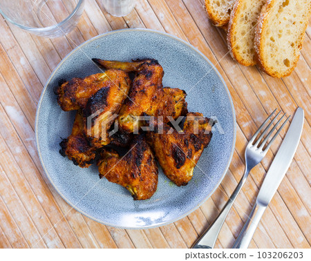 Grilled chicken wings served in the plate 103206203