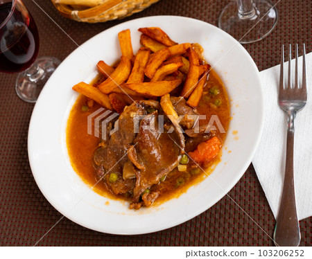 Braised beef in vegetable gravy with fried potatoes Braised beef in vegetable gravy with fried potatoes 103206252