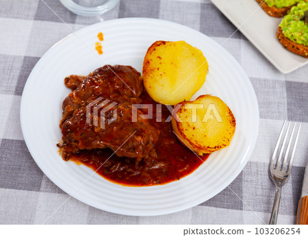 Fried pork cheek served on dish with potatoes Fried pork cheek served on dish with potatoes 103206254