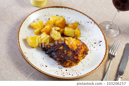 Baked chicken piece and potato in the plate 103206257