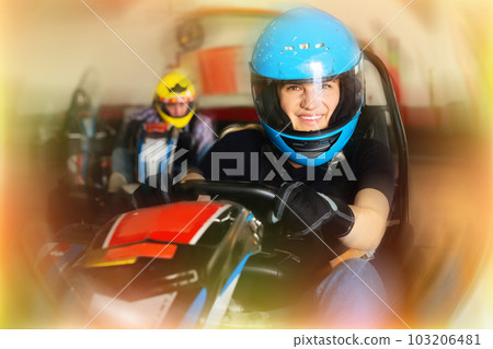Female driving go-kart car indoor Female driving go-kart car indoor 103206481