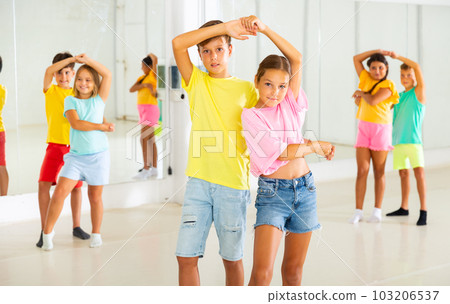 Boys and girls enjoying active dance in studio Boys and girls enjoying active dance in studio 103206537