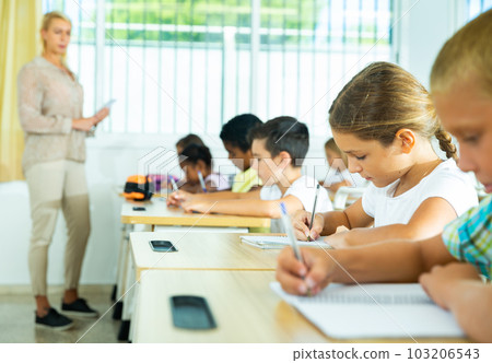 Group of focused kids working at class Group of focused kids working at class 103206543