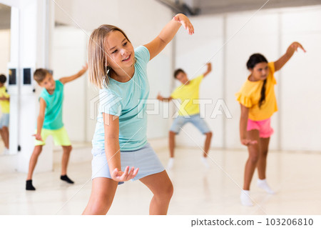 Group of kids training modern dance moves Group of kids training modern dance moves 103206810