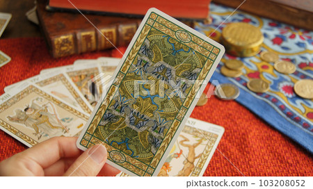 hand holding a tarot card 103208052