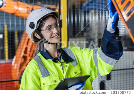 Female technician modern factory, Technical supervisor of robot operation department. Female technician modern factory, Technical supervisor of robot operation department. 103208773