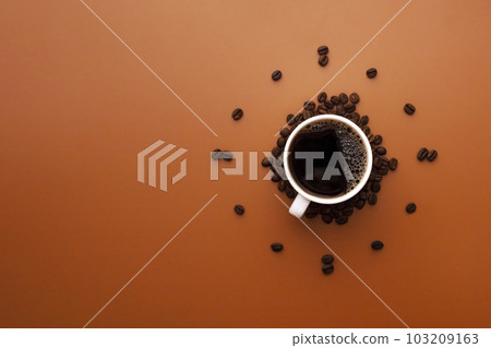 White coffee cup on brown background with coffee beans forming clock face 103209163