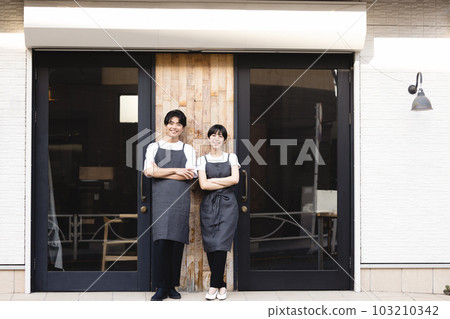 Men and women working at a cafe 103210342