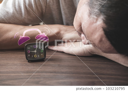 morning nap of Thai men and alarm clock. 103210795